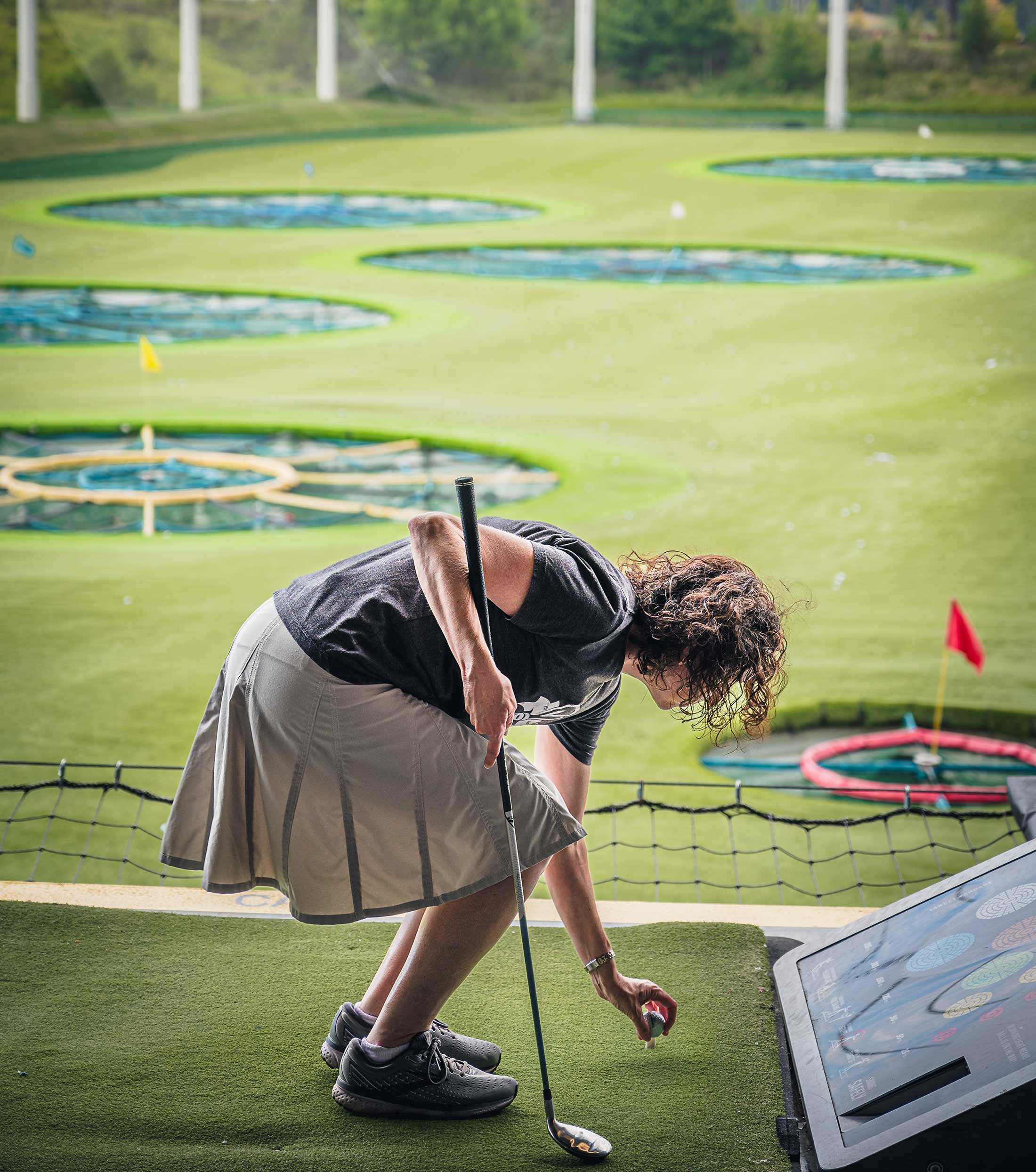 Gather Golfer lady setting up her ball
